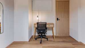 A room with a wooden desk, a black office chair, a whiteboard, and a door. - Comfortable Private Suite in Condesa area (18) (Mexico)