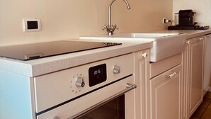 A kitchen with a built-in oven, a sink, and a coffee maker. - Liguria - Galleria Goito La Spezia (La Spezia)
