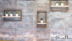 A wall with four wooden-framed shelves, each holding a potted plant. - Mountain Views, Pool & Rooftop: Cozy 2BR for 6 REF034 (Fuengirola)