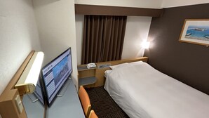 A hotel room with a bed, a desk with a computer, a telephone, and a wall-mounted TV. - Hotel Alpha-One Mishima (Mishima)
