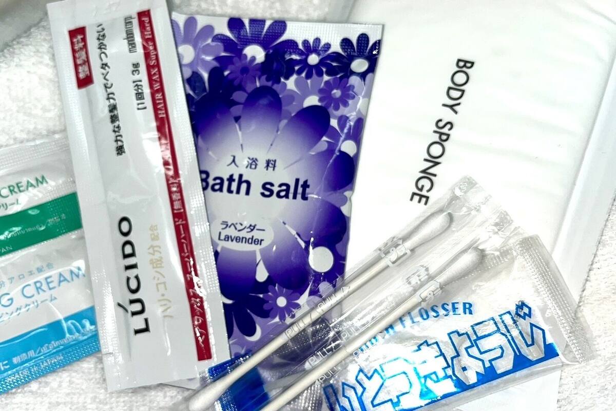 A variety of personal care products including shaving cream, body sponge, and bath salt.