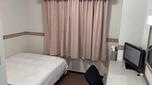 A hotel room with a single bed, a desk with a computer, and a window with curtains. - Hotel Alpha-One Sabae (Sabae)