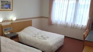 A hotel room with two beds, a nightstand with a phone, and a window with curtains. - Hotel Alpha-One Tsuruga-Bypass (Tsuruga)