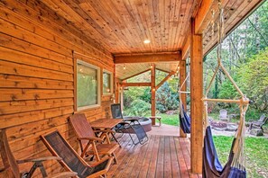 A wooden cabin with a deck, outdoor seating, and a hot tub. - Summer Lodge Life! 5bd+4bath+HotTub+Sauna+EV (Ashford)