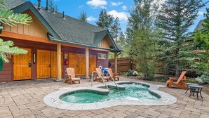 A lodge with a hot tub, wooden deck, and outdoor seating. - Spacious 2-bedroom 2.5 Bath Townhome Walking Distance to World Class Skiing!  (Keystone)