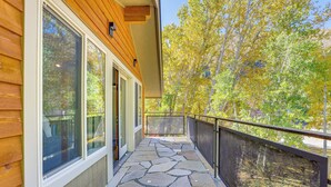 A stone-tiled balcony with a wooden exterior and large windows. - 14 Miles to Sun Valley: Updated Getaway! (Hailey)