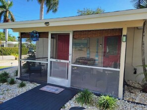 A single-story building with a covered entrance and a patio area.
