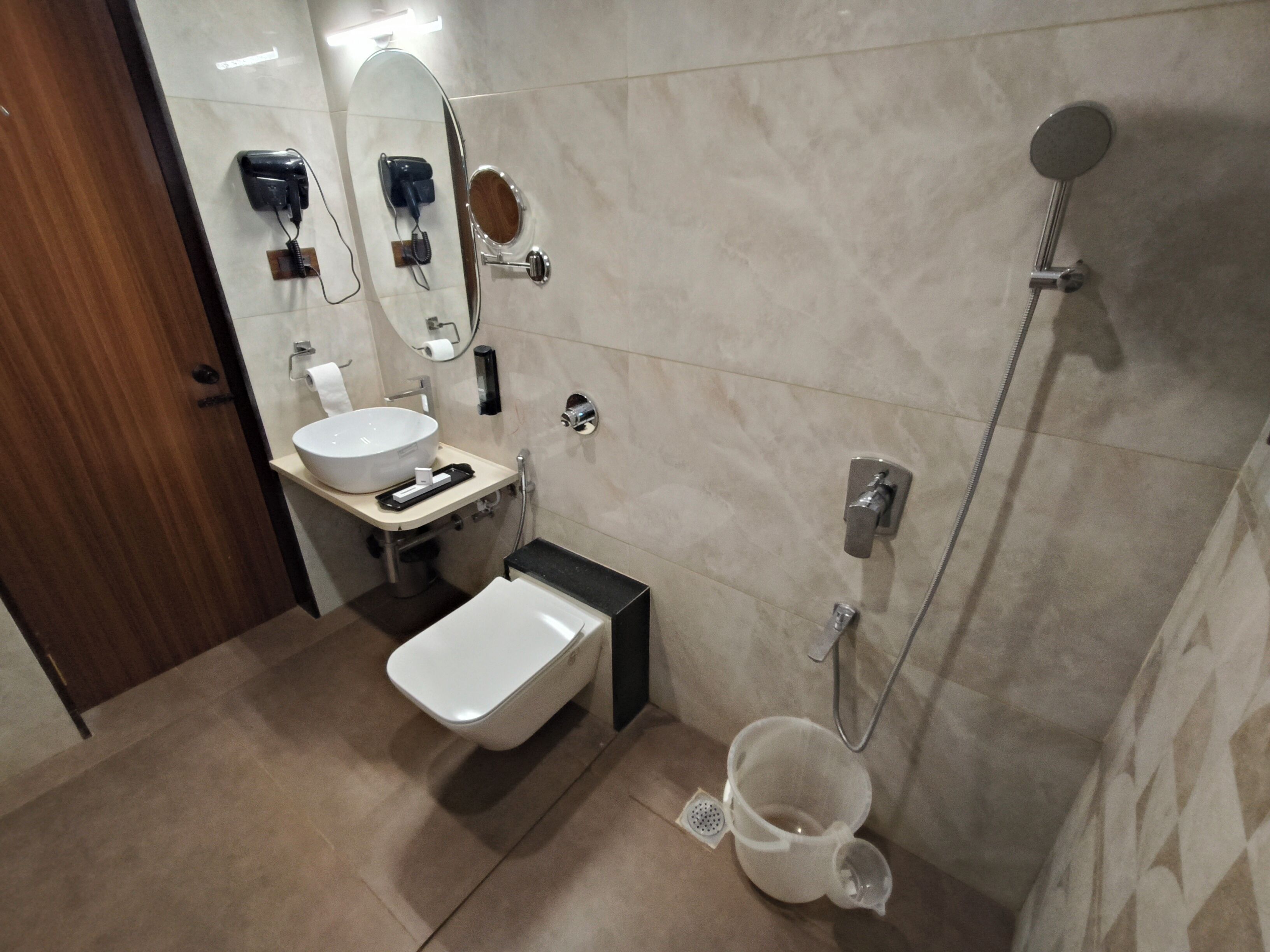 A modern bathroom with a sink, toilet, and shower.
