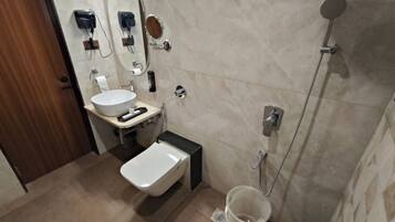 A modern bathroom with a sink, toilet, and shower.