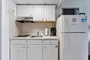 Fridge, microwave, coffee/tea maker, cookware/dishes/utensils