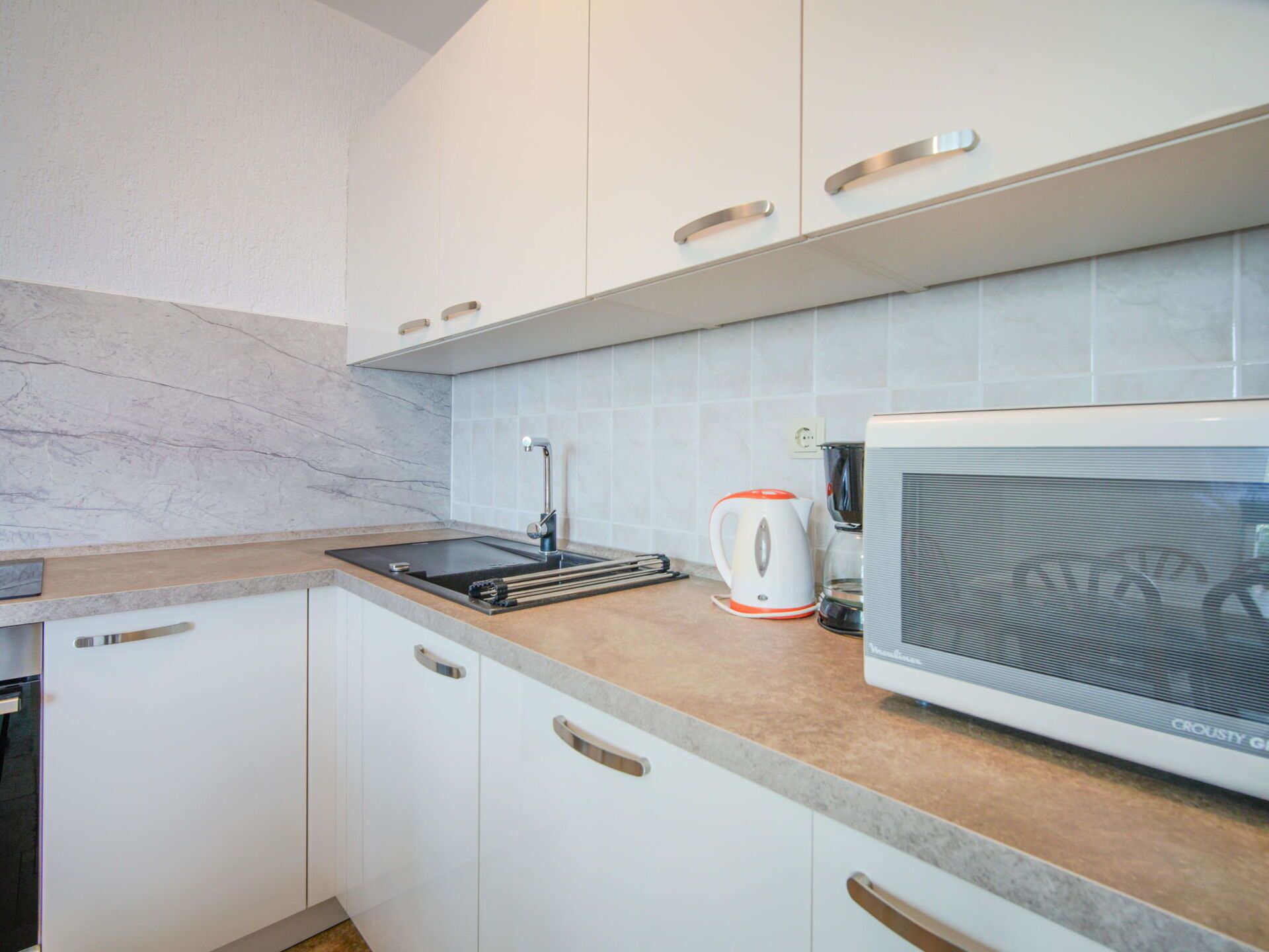 Countertop, Kitchen, Wood, Flooring, Kitchen Appliance, Interior Design, Major Appliance, Cabinetry, Floor, Room