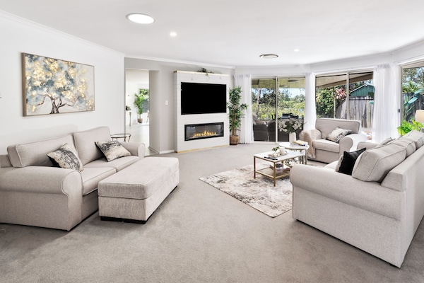 A living room where sunlight streams in by day. Cozy up and enjoy the view!