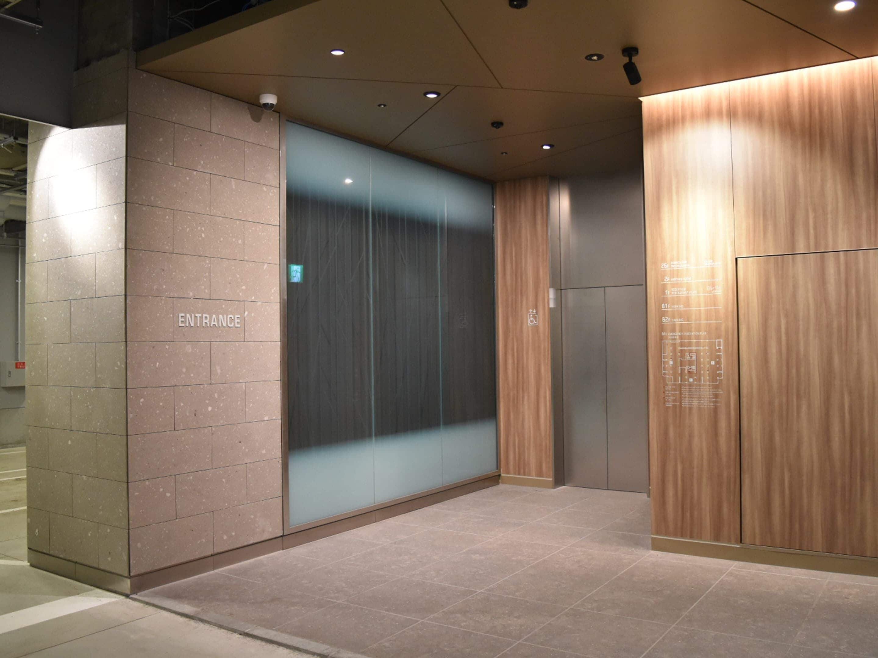 An elevator entrance with a sign indicating "ENTRANCE" and a wheelchair accessibility symbol.
