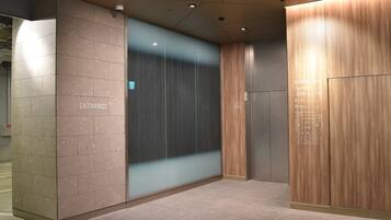 An elevator entrance with a sign indicating "ENTRANCE" and a wheelchair accessibility symbol.