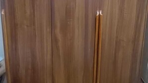 A large wooden wardrobe with two handles. - Shavin Residency Wardha Maharashtra (Wardha)