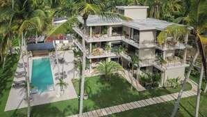 A multi-story modern house with a pool, surrounded by palm trees and greenery. - Coconut Beach House Playa Bonita Las Terrenas Dominican Republic (Las Terrenas)