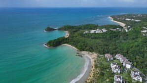 An aerial view of a coastal area with a beach, a small island, and a cluster of buildings. - Coconut Beach House Playa Bonita Las Terrenas Dominican Republic (Las Terrenas)