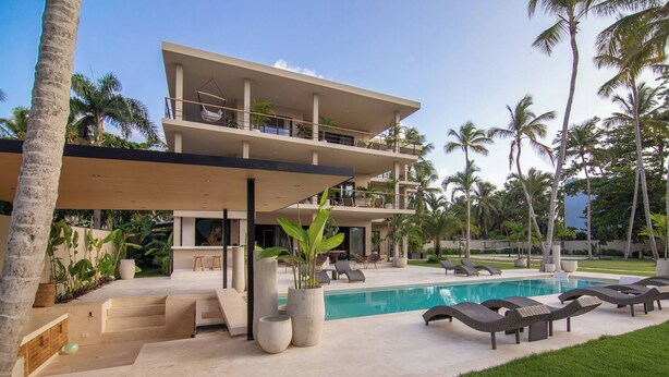 A modern two-story building with a pool, outdoor seating, and palm trees. - Coconut Beach House Playa Bonita Las Terrenas Dominican Republic (Las Terrenas)