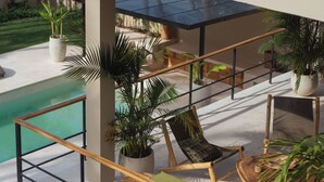 A multi-level outdoor lounge area with seating, a pool, and potted plants. - Coconut Beach House Playa Bonita Las Terrenas Dominican Republic (Las Terrenas)