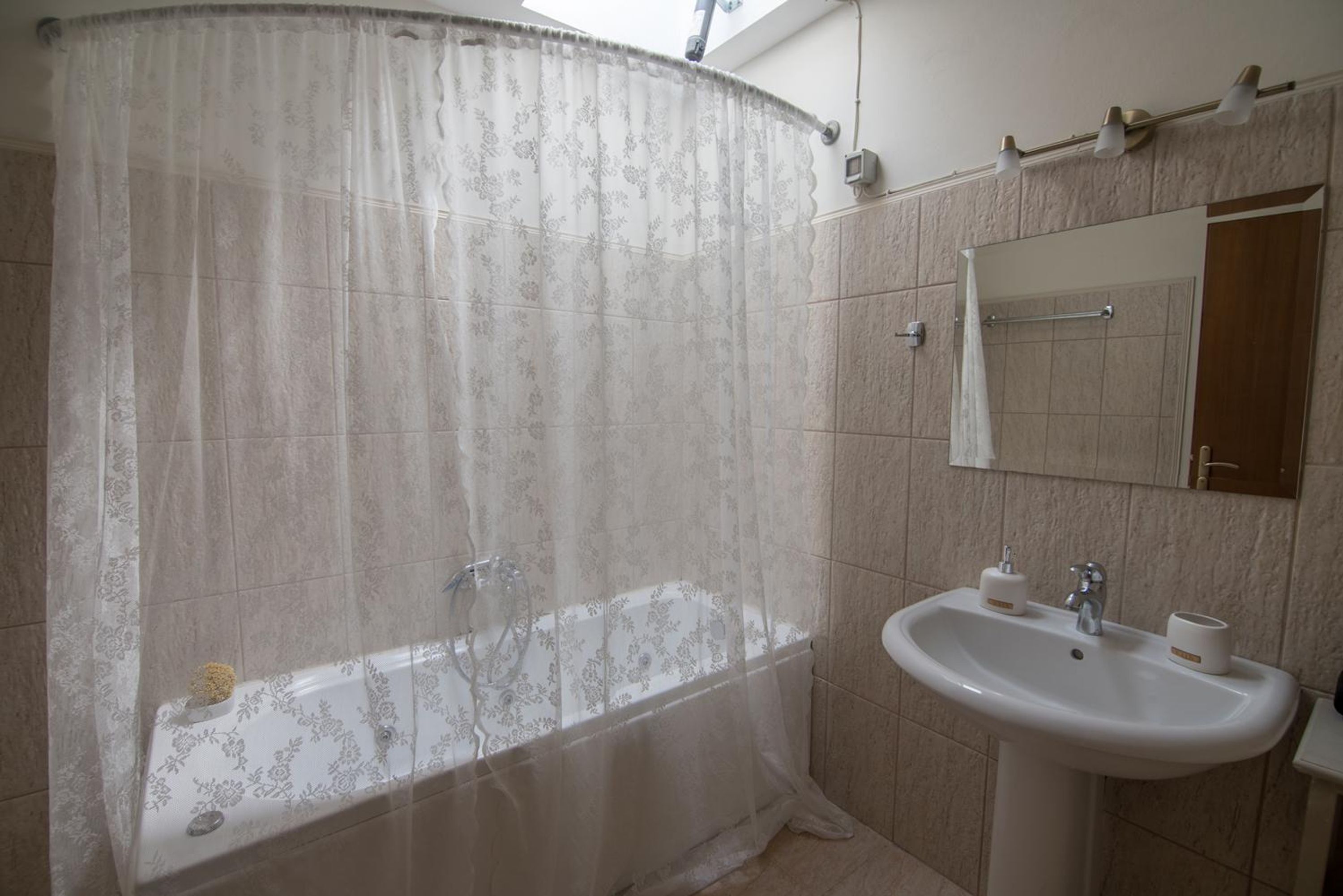 Ein Badezimmer mit Badewanne, Waschbecken und Spiegel.
