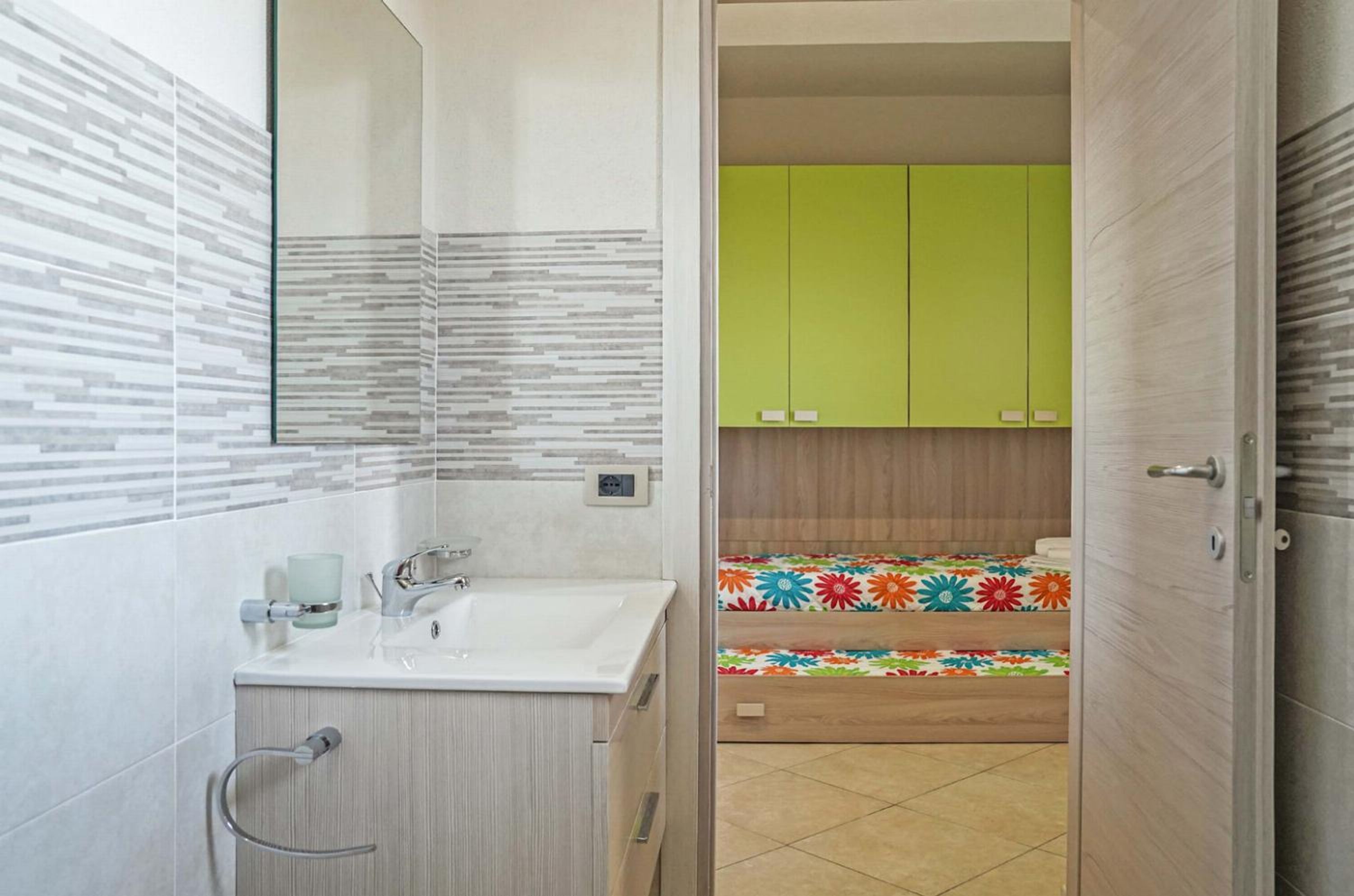A bathroom with a sink, mirror, and toilet.