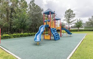 A playground with two slides and a climbing structure. - Luxurious 4-bedroom Apartment With Private Pool in Davenport (Davenport)