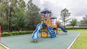 A playground with two slides and a climbing structure. - Book Now! Disney and Theme Parks Days, Poolside Family Villa Awaits! (Davenport)