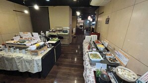 A buffet setup with various food items and serving utensils. - Hotel Alpha-One Yonago (Yonago)