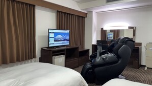 A hotel room with a bed, a massage chair, a TV displaying a hotel website, and a mirror. - Hotel Alpha-One Yonago (Yonago)