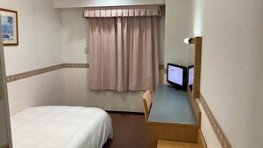 A hotel room with a bed, a desk with a computer, a chair, a window with curtains, and a framed picture on the wall. - Hotel Alpha-One Onomichi (Onomichi)