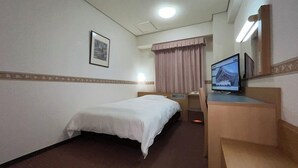 A hotel room with a single bed, a desk with a computer, and a television. - Hotel Alpha-One Izumo (Izumo)