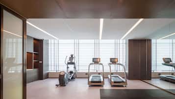 A modern gym with treadmills, an elliptical, and a stationary bike.