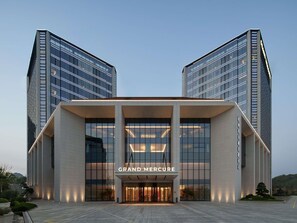 A modern building with a prominent entrance labeled 'GRAND MERCURE.' - Grand Mercure Hangzhou Qingshan Lake (Hangzhou)