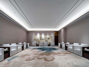 A modern hotel room with a large, abstract carpet, white furniture, and a large painting on the wall. - Grand Mercure Hangzhou Qingshan Lake (Hangzhou)
