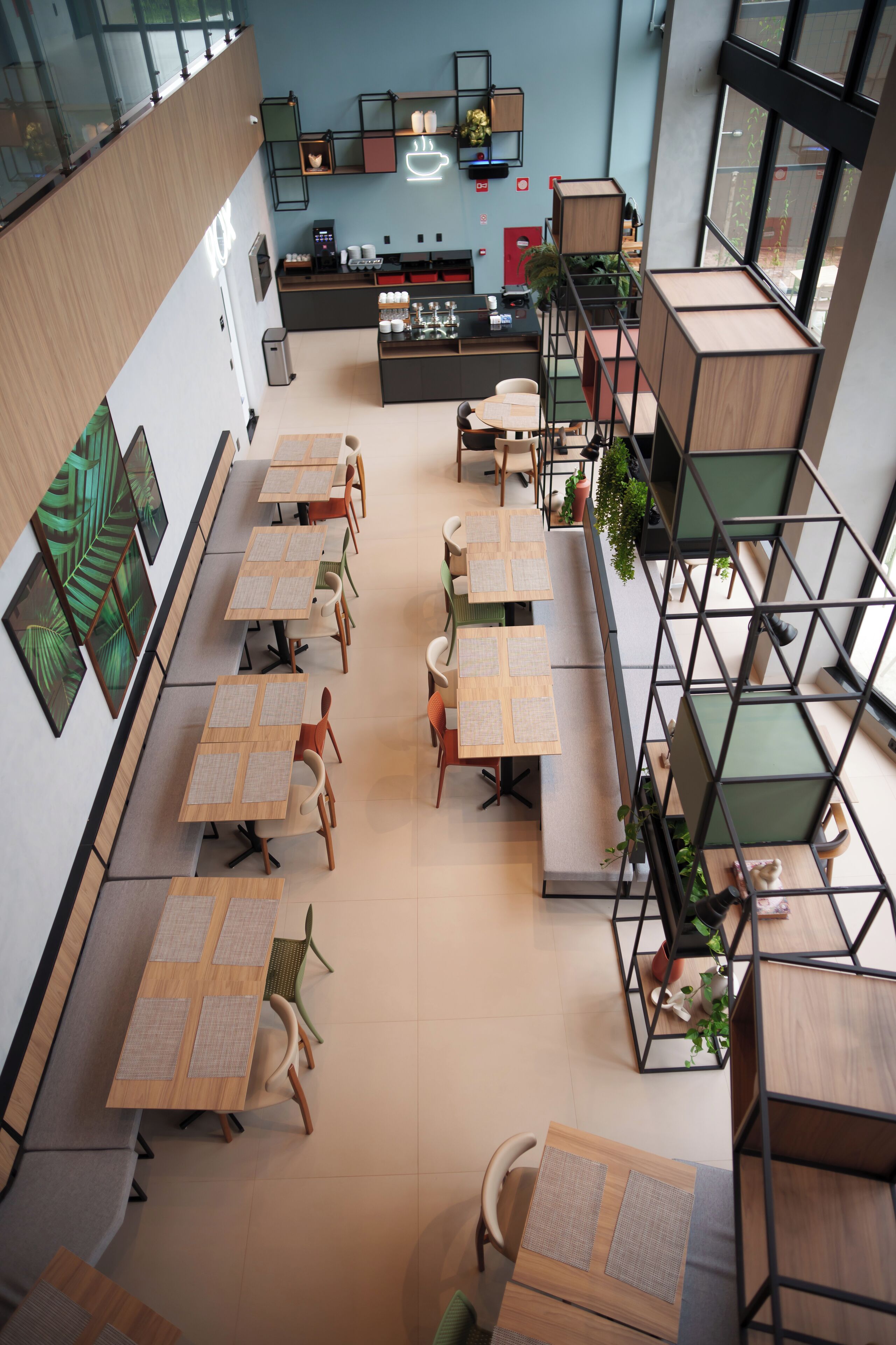 A modern interior with multiple seating areas, a kitchen, and a staircase.