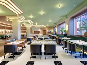 A spacious restaurant with high ceilings, modern lighting, and a view of the outdoors. - Mercure Garut City Center (Garut)