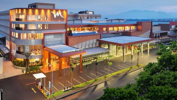 A multi-story hotel with a prominent 'Mercure Hotel' sign, a covered outdoor area, and a parking lot. - Mercure Garut City Center (Garut)