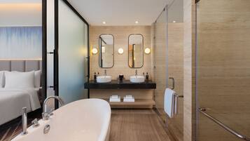 Junior Suite with King bed, city view, 15% F&B discount, 4 pieces laundry | Bathroom | Bathrobes, slippers, bidet, towels
