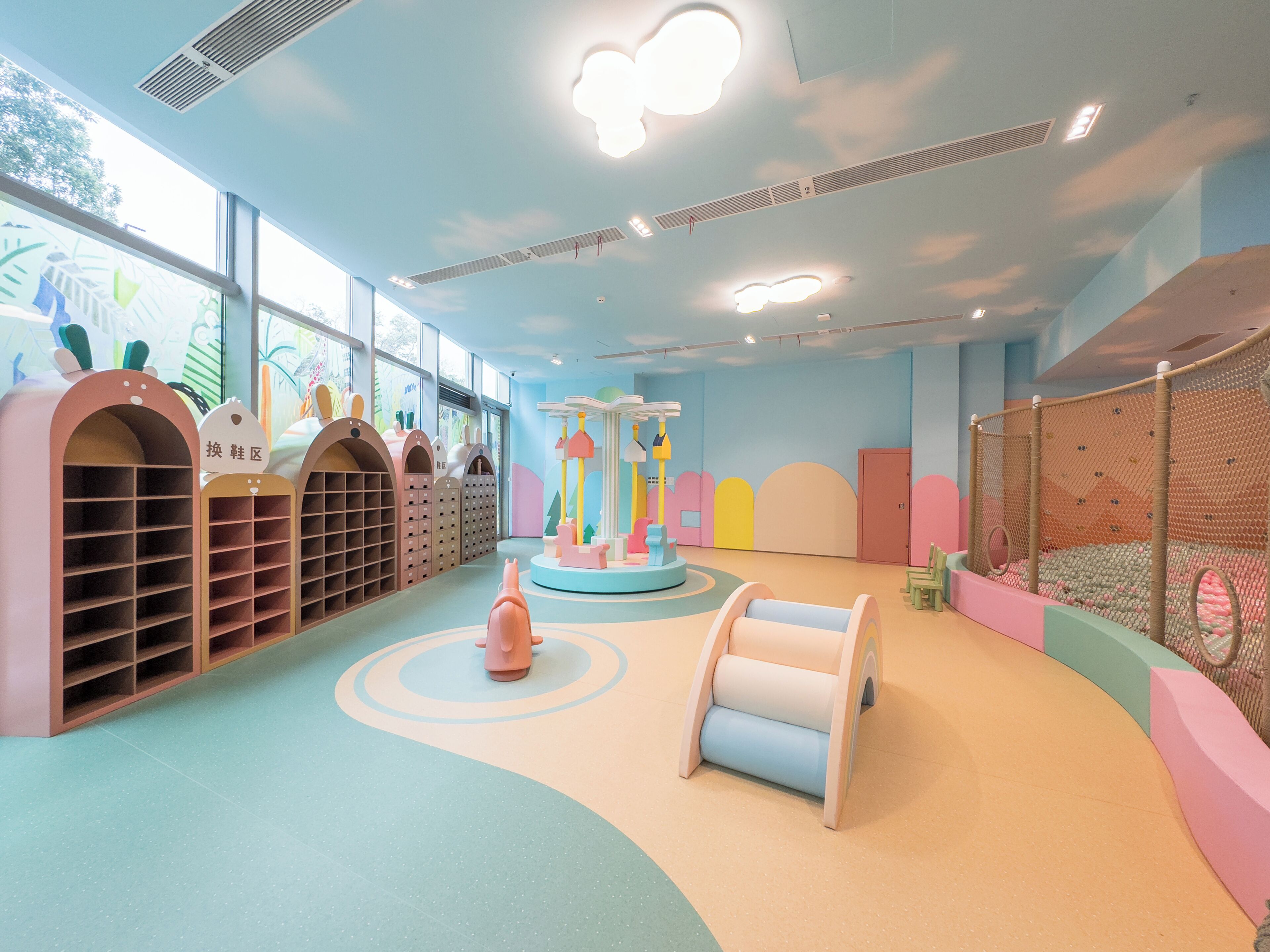 A children's play area with storage units, a ball pit, and a soft play structure.