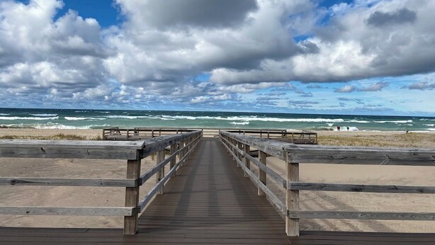 A wooden boardwalk leading to a beach with waves and a cloudy sky. - Amazing Lake Superior view from Ridge Road w/2 car heated garage, pet friendly (Grand Marais)