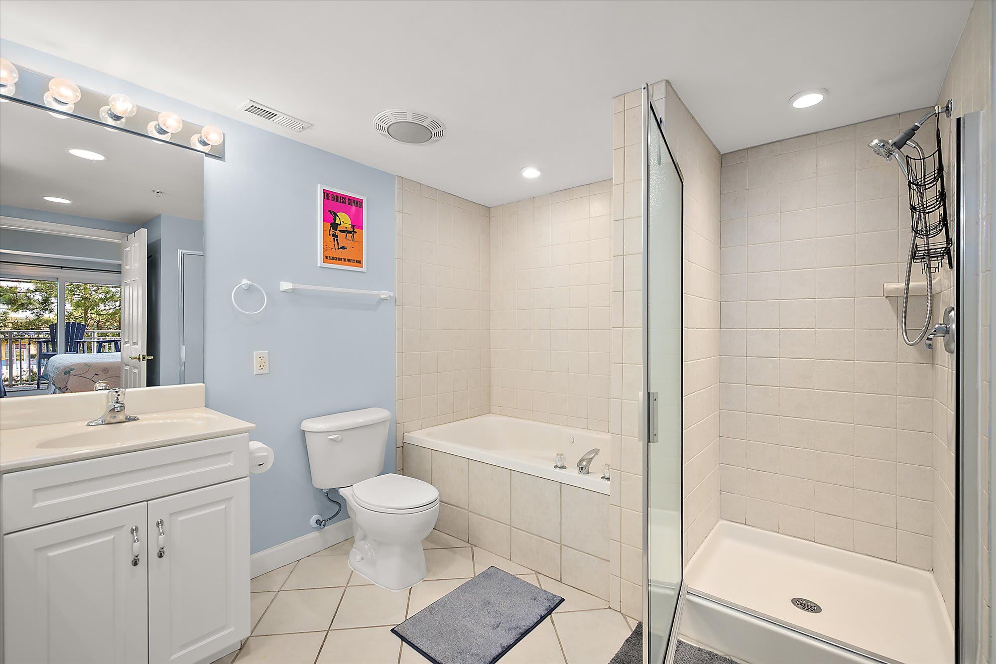 A bathroom with a toilet, sink, bathtub, and shower.