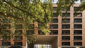 A multi-story building with a brick facade, large windows, and a central courtyard. - Symphony Atal City Square (Wroclaw)