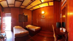 A room with two beds, a desk, a chair, a television, and a wooden ceiling. - Dragon Inn Floating Resort Semporna (Semporna)