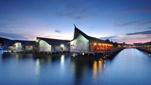 A waterfront resort with overwater bungalows and a long pier. - Dragon Inn Floating Resort Semporna (Semporna)