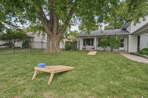 A residential property with a lawn, a tree, and a house with a porch. - Spacious Family & Work-Friendly 3BD w/ Workspace, Fire Pit & Park Views Near Campus (Champaign)