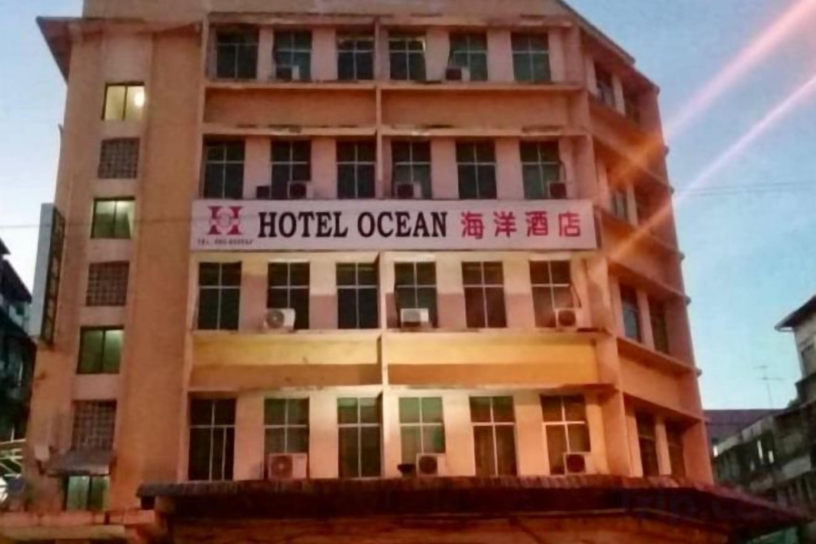A multi-story hotel building with a sign that reads 'HOTEL OCEAN.'