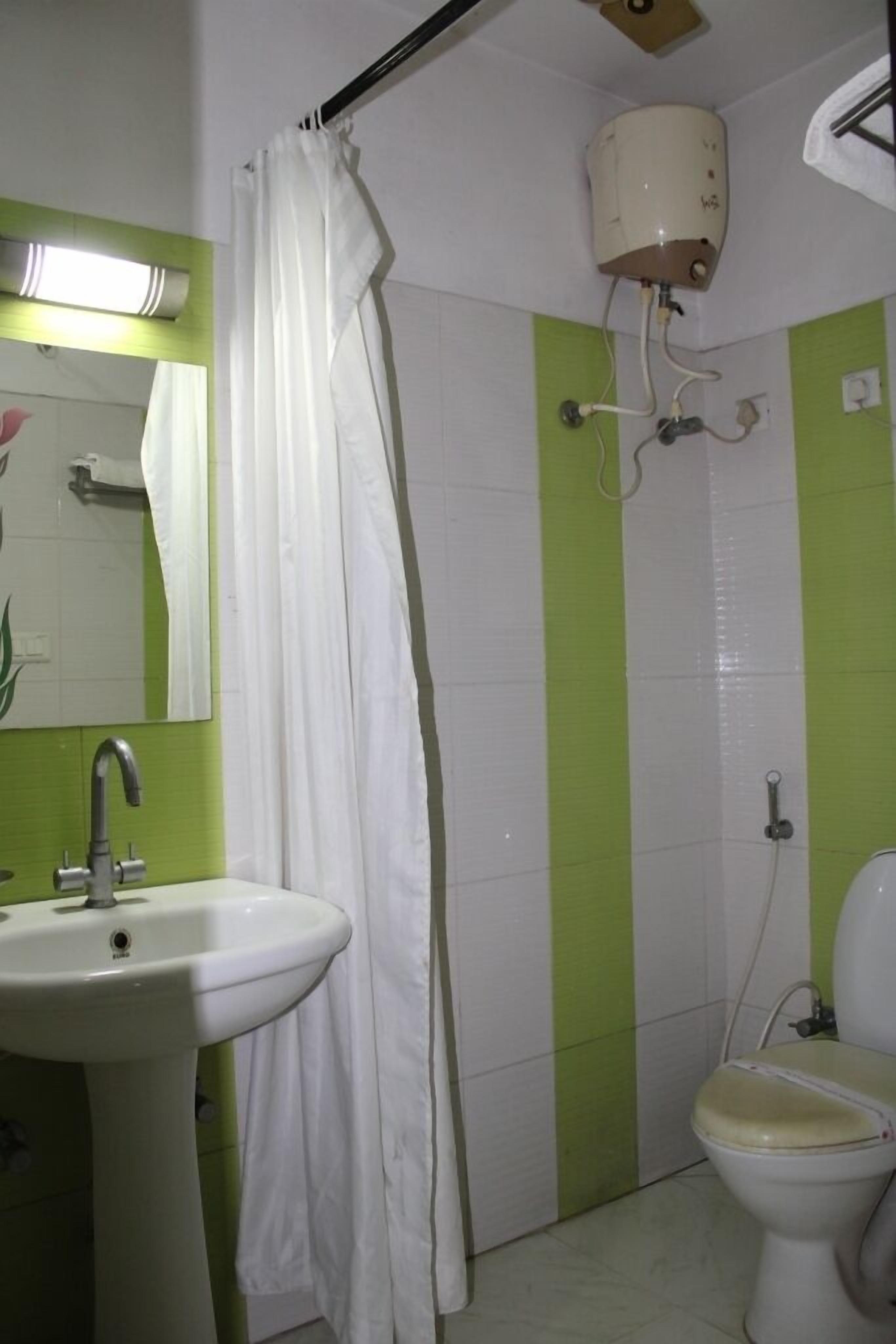 A bathroom with a sink, toilet, and shower.