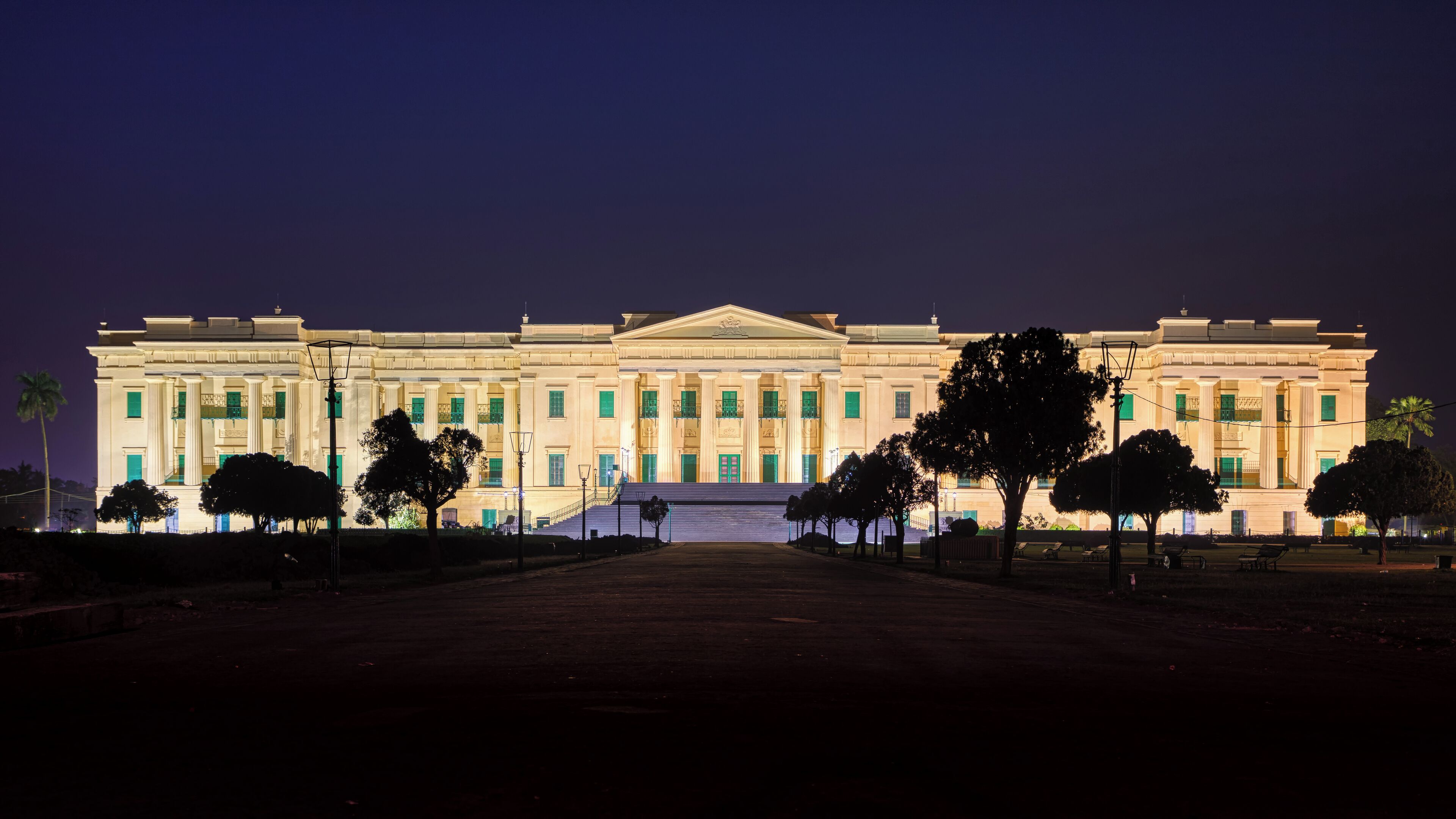 A large, well-lit building with a symmetrical facade, columns, and a central entrance.