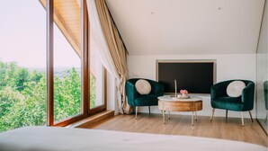A room with a large window, two chairs, a small round table, and a blackboard on the wall. - Nice home in Vukanovec with sauna (Vukanovec)