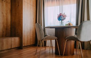Enjoy meals in this dining area with a round table, two chairs, and a beautiful centerpiece.